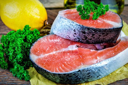 Photo for Steaks of red fish with parsley and lemon - Royalty Free Image
