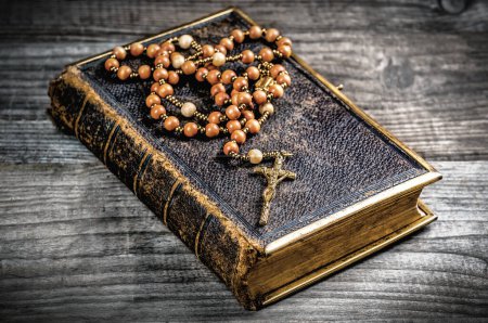 Photo for Vintage rosary beads on old holly Bible - Royalty Free Image