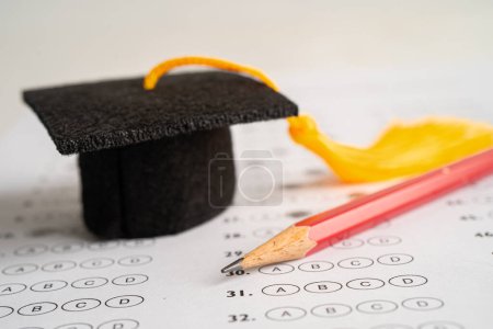 Photo for Graduation hat and pencil on Answer sheet background, Education study mathematics learning teach concept. - Royalty Free Image