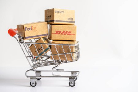 Photo for Bangkok, Thailand - September 26, 2022 Shopping cart with DHL Amazon express packing box, import export online exchange investment business. - Royalty Free Image