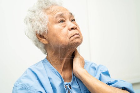 Photo for Asian senior woman patient neck pain while sitting  in nursing hospital, healthy strong medical concept. - Royalty Free Image