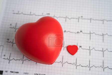 Photo for Red heart on electrocardiogram ECG with red heart, heart wave, heart attack, cardiogram report. - Royalty Free Image