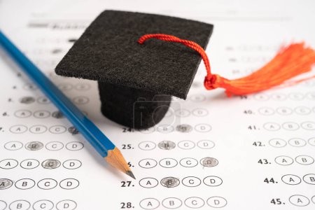 Photo for Graduation gap hat and pencil on answer sheet background, Education study testing learning teach concept. - Royalty Free Image