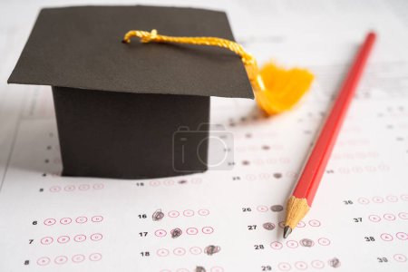 Photo for Graduation gap hat and pencil on answer sheet background, Education study testing learning teach concept. - Royalty Free Image