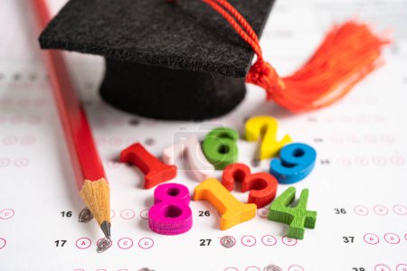 Photo for Graduation gap hat and pencil on answer sheet paper, Education study testing learning teach concept. - Royalty Free Image