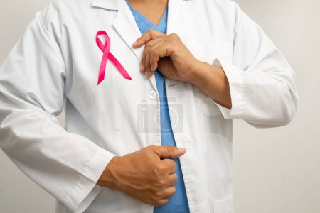 Photo for Breast cancer, Asian doctor woman with pink ribbon, symbol of World Breast Cancer Day. - Royalty Free Image