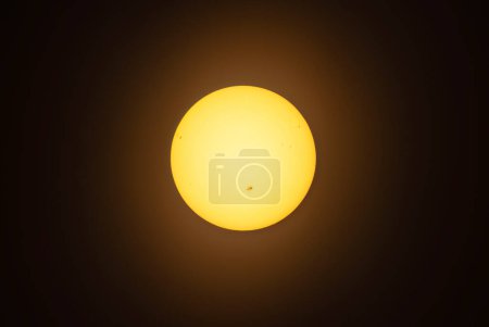 Photo for The sun glowing with many sunspots using a homemade solar filter - Royalty Free Image