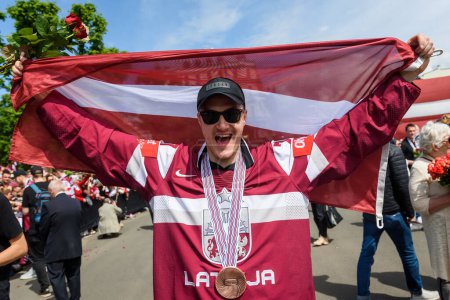 Photo for RIGA, LATVIA. 29th May 2023. Kristaps Zile, IIHF Worlds 2023 Bronze Medalist of Latvian Men's Ice Hockey team arrival massive celebration at Monument of Freedom. - Royalty Free Image