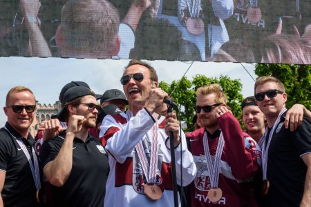 Photo for RIGA, LATVIA. 29th May 2023. Renars Kaupers (C), vocal of band Brainstorm. IIHF Worlds Bronze Medalists Latvian Men's Ice Hockey team arrival massive celebration at Monument of Freedom. - Royalty Free Image