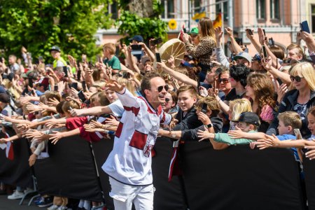 Photo for RIGA, LATVIA. 29th May 2023. Renars Kaupers (C), vocal of band Brainstorm. IIHF Worlds Bronze Medalists Latvian Men's Ice Hockey team arrival massive celebration at Monument of Freedom. - Royalty Free Image