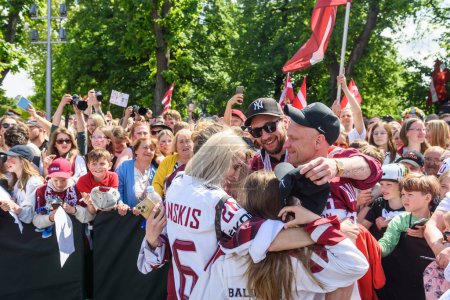 Photo for RIGA, LATVIA. 29th May 2023. Uvis Balinskis with his family, IIHF Worlds 2023 Bronze Medalist, Latvian Men's Ice Hockey team arrival massive celebration at Monument of Freedom. - Royalty Free Image