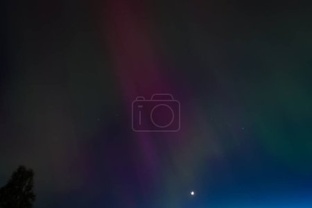 CARNIKAVA, LATVIA. 10th May 2024. Selective focus photo. Impressive northern lights, aurora borealis in the sky.