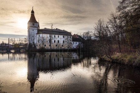 Téléchargez les photos : Le château d'eau de Blatna au coucher du soleil d'automne dans la région de Bohême du Sud est l'un des manoirs d'eau les mieux conservés de la République tchèque. - en image libre de droit