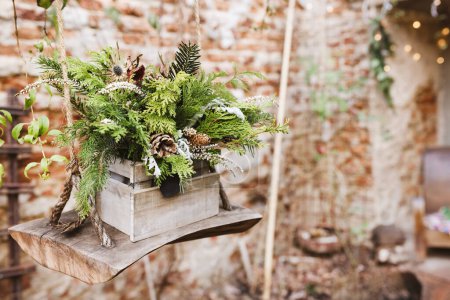 Photo for Natural DIY outdoor Christmas decoration in garden. Pine branches and pine cones in box. Environment, recycle, reuse and zero waste concept. Selective focus, focus space - Royalty Free Image
