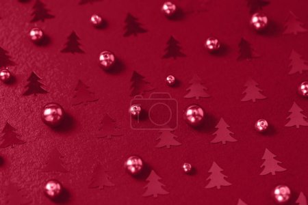 Photo for Pearls and Christmas tree foil confetti in trendy color of the year 2023 Viva Magenta. Creative abstract background. Winter, Christmas, New Year celebration concept. Holiday flat layout - Royalty Free Image