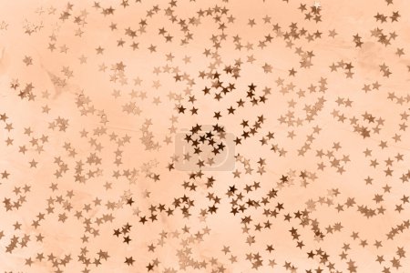 Color of the year 2024 Peach Fuzz. Trendy color. Christmas festive abstract background with stars