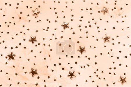 Color of the year 2024 Peach Fuzz. Trendy color. Christmas festive abstract background with stars