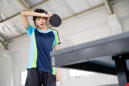 Photo for Female ping pong athlete tired and down with match results - Royalty Free Image