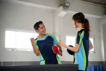 Photo for Two ping pong players compete excitedly when they score points at the ping pong table - Royalty Free Image