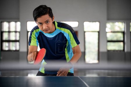 Photo for Close up of a male ping pong player in a position ready to compete in a ping pong match - Royalty Free Image