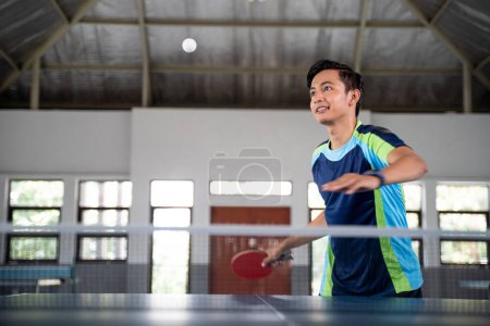 Photo for Dropped balls will be received on a paddle by the male players at the ping pong table - Royalty Free Image