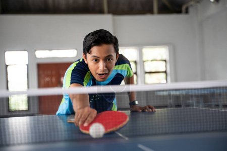 Photo for Male ping pong player does not get the ball that falls in his area on the ping pong table - Royalty Free Image