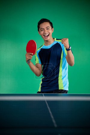 Photo for Asian male players excited to win a ping pong match - Royalty Free Image