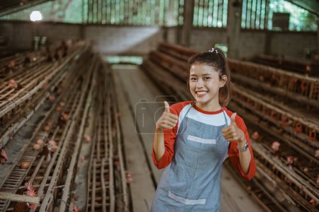 Téléchargez les photos : Asiatiques femmes agriculteurs heureux de montrer pouces sur les fermes de poulet - en image libre de droit