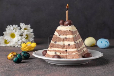 Traditional Easter cottage cheese dessert with chocolate, as well as a colorful eggs on dark gray background