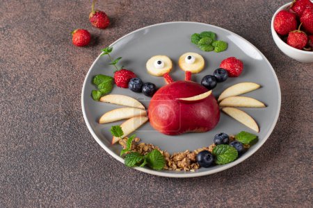 Sea crab made from fruits and berries such as apple, strawberry and blueberry - serving option for children, Closeup