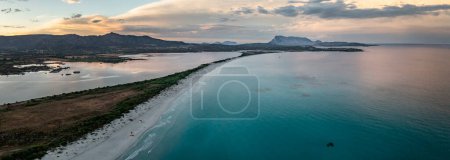 Photo for San Teodoro sand beach with lagoon, mountain of island Tavolara and coastline in Sadinia Italy from above during sunset, clouds in sky - Royalty Free Image