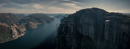 Photo for Panorama landscape of Preikestolen rock with view into Lysefjord in Norway, steep cliff in the mountains with a platform, sunny day with blue water in the fjord - Royalty Free Image