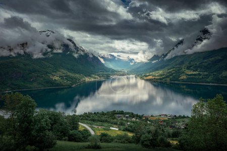Foto de Nordfjord fjord with tourism cruise ships in summer in Norway, dark clouds over the mountains - Imagen libre de derechos