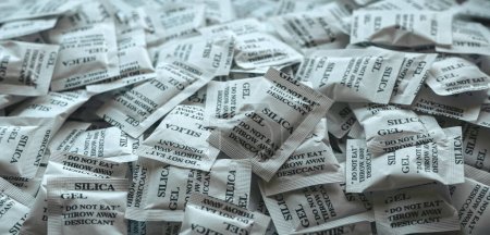A bunch of desiccant or silica gel in white paper packaging.