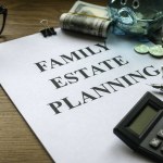 Family estate planning. Property investment and house mortgage financial real estate concept. Document, money, calculator, glasses and key on wooden table.