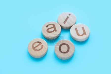 Photo for Learning english concept.Vowels of AEIOU on a blue background. - Royalty Free Image