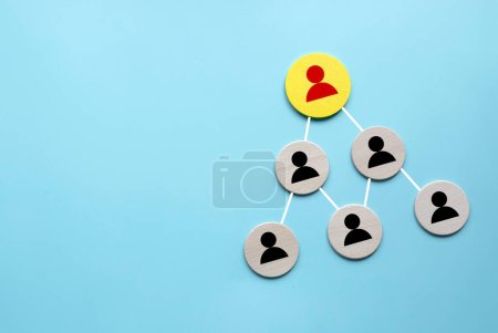 Photo for Company hierarchical organizational chart of wooden circle on blue background with copy space. - Royalty Free Image