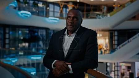 Photo for Middle-aged African entrepreneur ethnic man worker businessman indoors answer call listening good news by mobile phone calling talk victory achievement winning smartphone talking happy business offer - Royalty Free Image