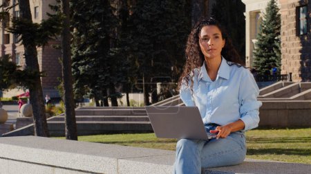 Photo for Business woman finishing work online studying with computer sitting in city outdoors. Girl student closes laptop stop typing browsing resting relaxing on building company background enjoying calm - Royalty Free Image