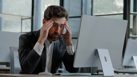 Photo for Tired Caucasian bearded 40s middle-aged businessman employee man typing laptop feel failure upset with lost of information online error stressed look at computer screen suffer from headache pressure - Royalty Free Image