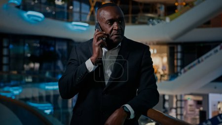 Photo for Ethnic middle-aged man entrepreneur answer phone call talking smartphone talk cellphone listen bad news frustrated loose money lost job notification bank reject failure reaction stressed businessman - Royalty Free Image