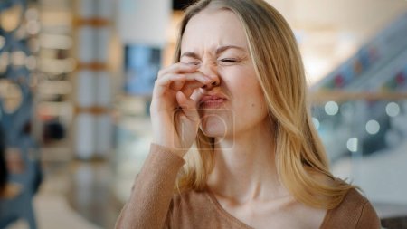 Photo for Portrait young caucasian woman with rhinitis runny nasal virus illness sneezes wipes with paper napkin in shopping mall student girl suffer from seasonal allergy dusty nose irritation disease symptoms - Royalty Free Image