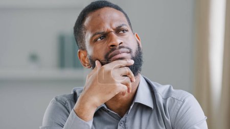 Photo for Pensive ethnic bearded African American man thinking businessman searching solution of difficult problem boss think ponder business strategy dreaming thoughtful pondering in office deep in thoughts - Royalty Free Image