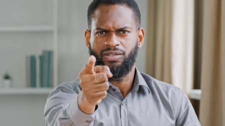 Foto de Mad angry aggressive bearded African American businessman professional HR manager employer man office worker pointing finger at camera work threat warning promise dismissal hey you bad work reaction - Imagen libre de derechos