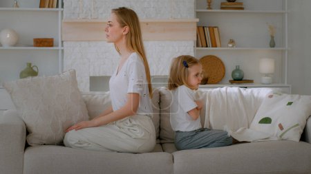 Foto de Little abuse child girl sad upset daughter adopted kid ignore unhappy offended mother family disagreement sitting at home couch looking to different sides annoy relationship problem conflict quarrel - Imagen libre de derechos