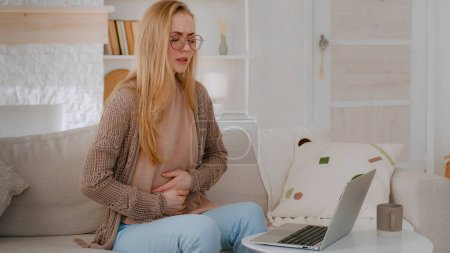 Photo for Sick ill girl student business woman unwell lady in glasses Caucasian illness female with laptop at home feeling bad abdomen pain belly ache suffering stomach aching hurt painful menstrual period lly - Royalty Free Image