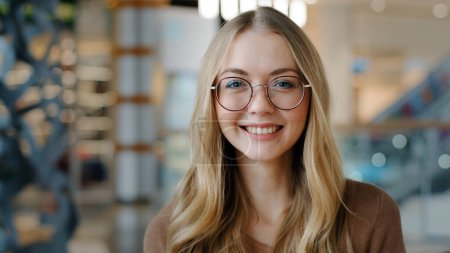 Photo for Head shot happy portrait caucasian girl in glasses young woman satisfied with ophthalmology services millennial blonde with healthy white toothy smile looking at camera confident model posing indoors - Royalty Free Image
