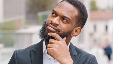 Téléchargez les photos : Ethnic bearded African American man entrepreneur pensive manager executive thoughtful worker employer ponder think about business problem solution career decision planning company strategy thinking - en image libre de droit