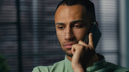 Photo for Serious worried excited latin american man talking mobile phone sad frustrated confused young businessman hear bad news feel stress experience have problem unpleasant remote conversation on smartphone - Royalty Free Image