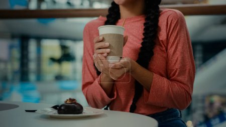 Photo for Unknown woman client customer girl sit at cafe restaurant buy coffee and chocolate healthy calorie-free dessert female visitor drinking aroma hot cappuccino espresso herbal tea relaxing after shopping - Royalty Free Image